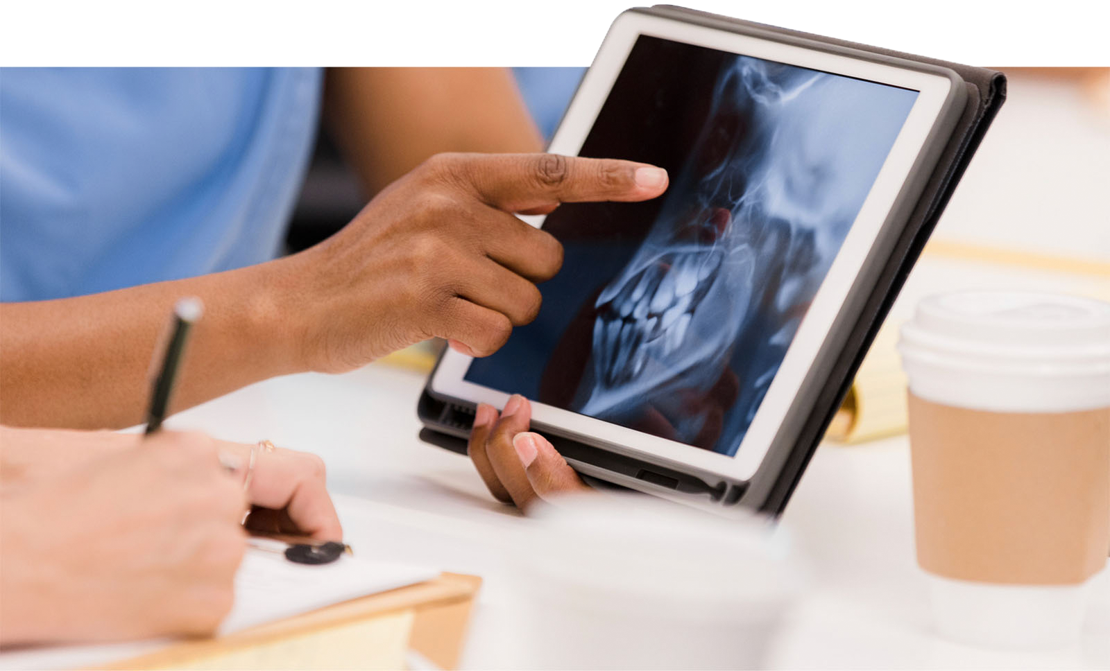 Clinician shows x-ray image on tablet